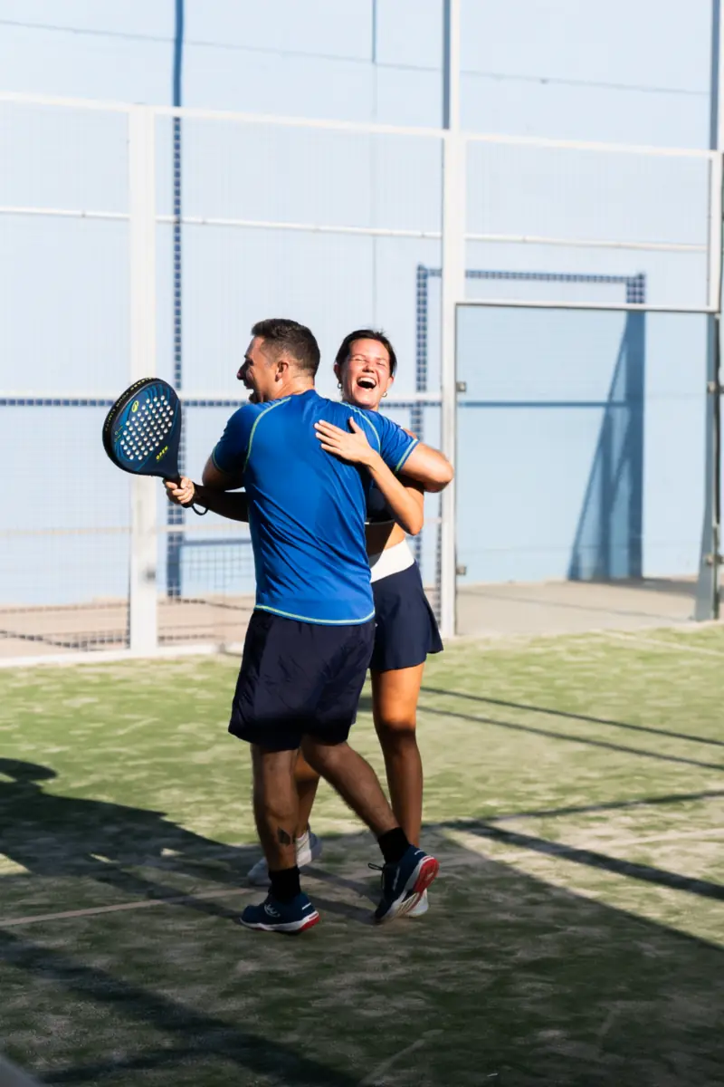 Two players hugging on court to celebrate a point