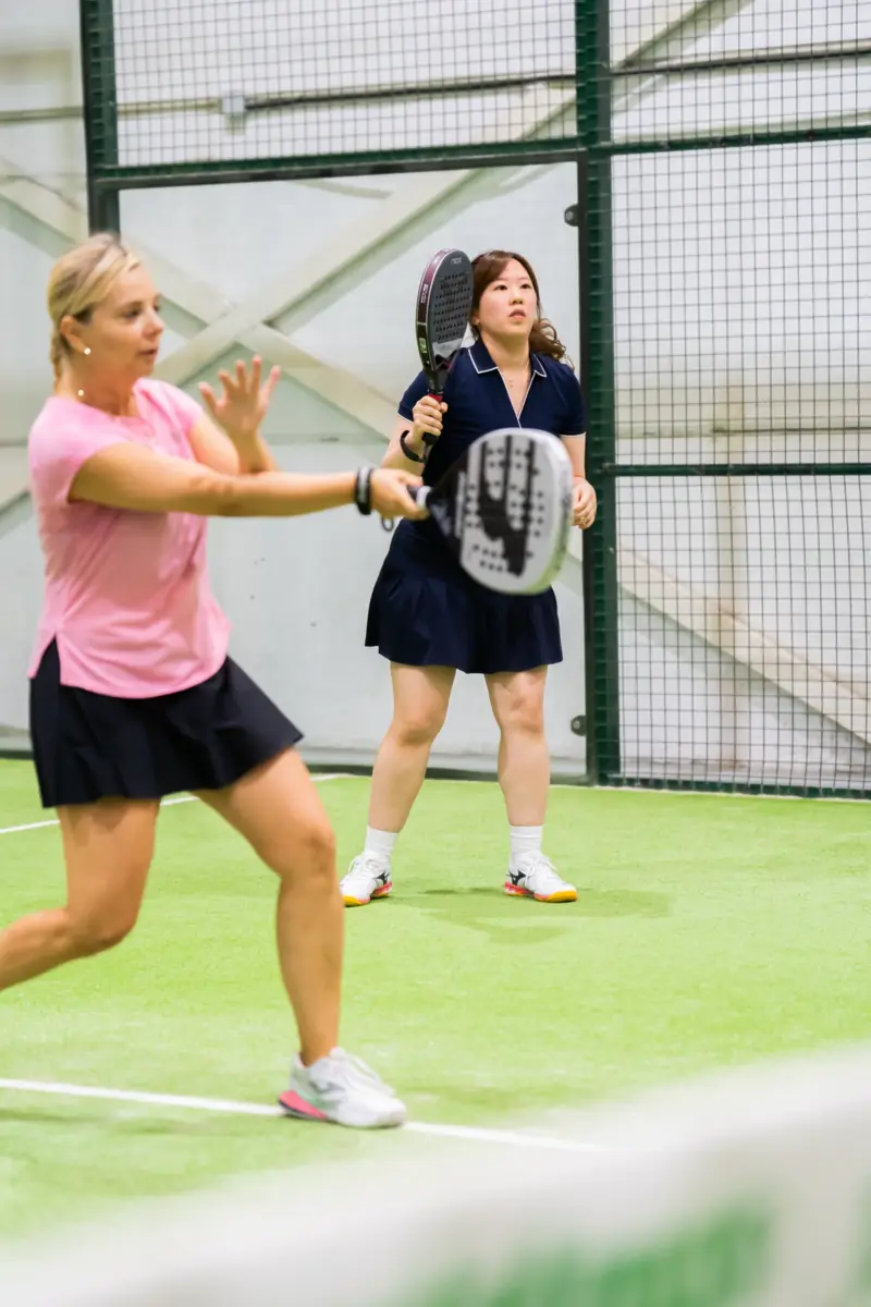 Two players during a drill on an indoor court
