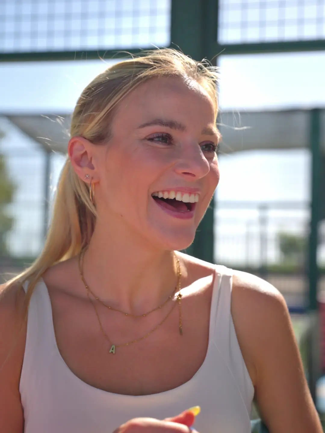 A player laughing on court during an OSU Padel Saturday Social in Valencia