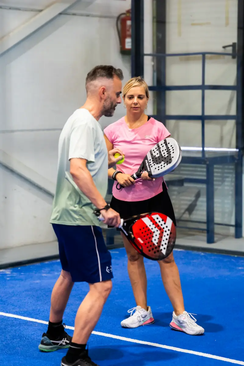 Iván giving tips to a player on court